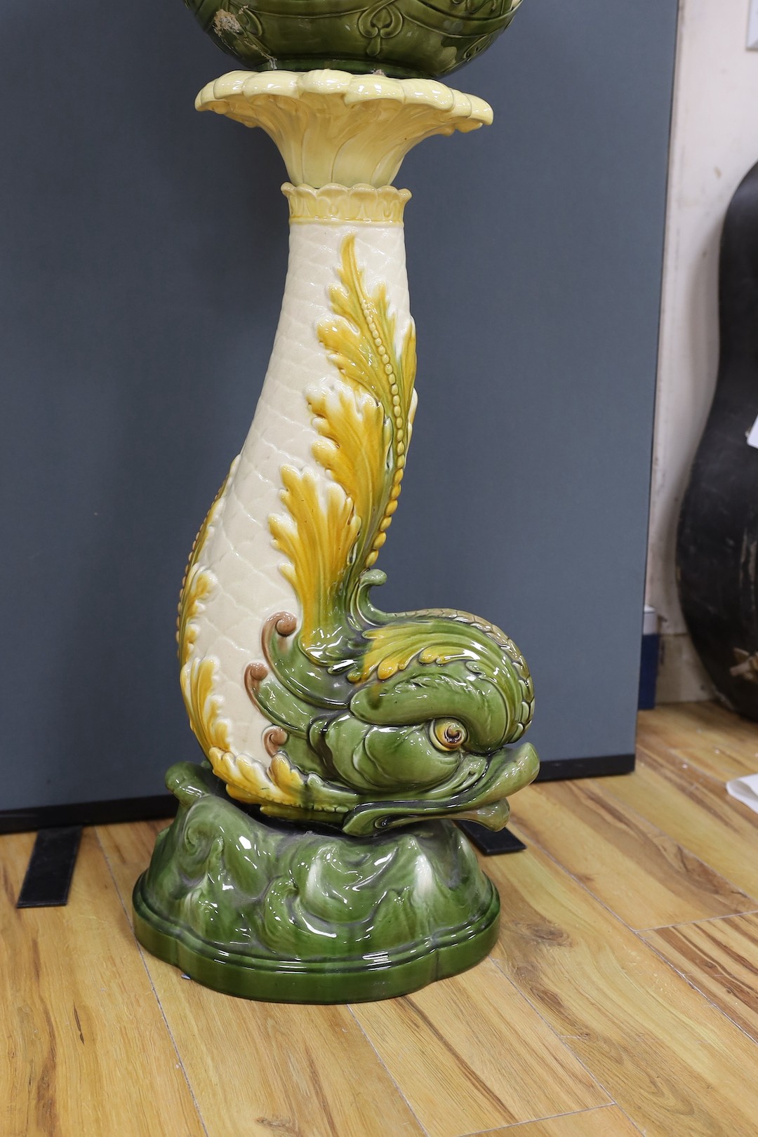 A Leeds Art pottery floral jardinière, on rearing dolphin pedestal - 114cm high